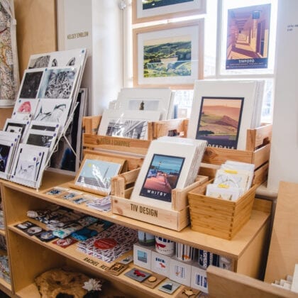 A shop displays post cards and customised products.