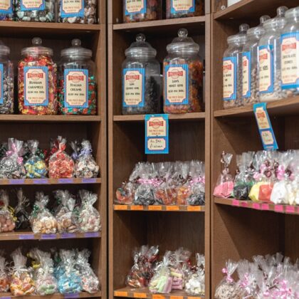 Sweet jars line the shelves of a sweet shop.