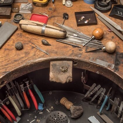 A workman's bench adorned with tools and files of all kinds.