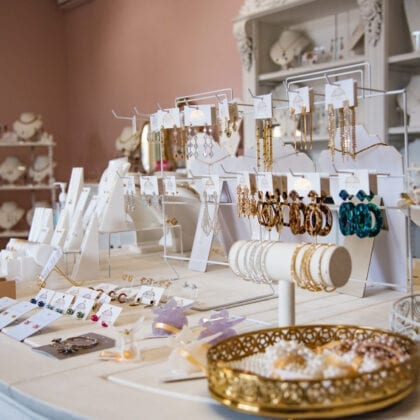 A table contains a plenty of jewellery stands, carry a multitude of jewellery.