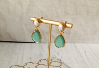 small jade earrings on stand