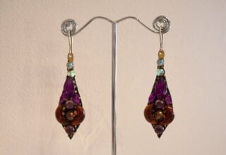 large jewelled earrings on stand