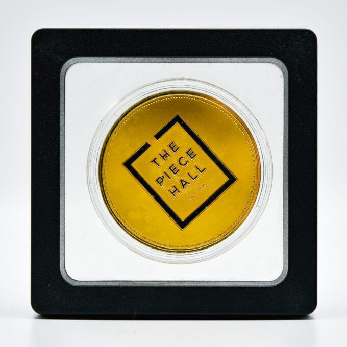 The piece hall coin, displayed in case.