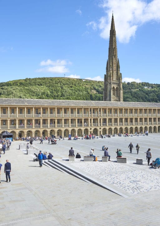 The piece hall courtyard, populated by visitors on a sunny day.