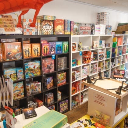 Board games and other games line the walls of the store.